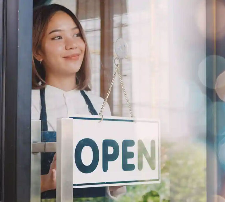 Person behind open sign in store