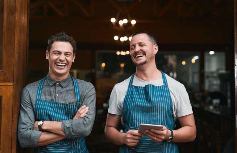 Team, restaurant and men with tablet or online, professional and people for small business startup. Laughing, portrait and pride for success in career in hospitality service, growth and together.